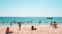 Guests enjoying a sandy beach with ocean access at the resort