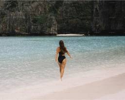 Guest walking into the water at the hotel beach area