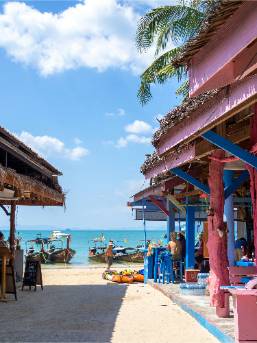 Beachfront view with colorful buildings and boats by the shore
