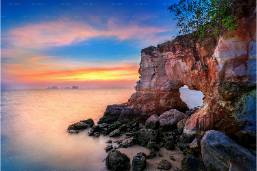 Rock formation near the ocean at sunset by the hotel beach