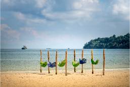 Beach area with swings facing the ocean at a hotel resort
