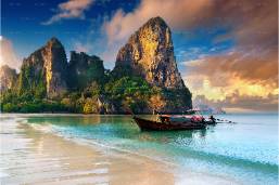 Beachfront with clear water and limestone cliffs at sunset