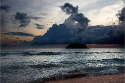 Ocean view with island and clouds at beachfront hotel