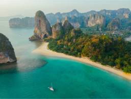 Beachfront area with clear water and limestone cliffs