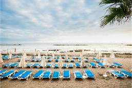 Rows of beach loungers and umbrellas along the sandy hotel beach