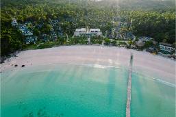 Beachfront resort with sandy shore and clear turquoise water