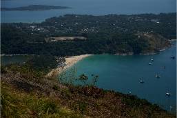 View of a beach with boats near a coastal hotel area