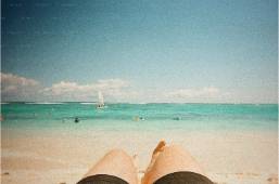 View of beach and ocean from a guest's perspective on sandy shore