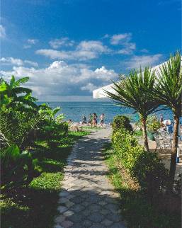 Pathway leading from hotel garden to beach with ocean view