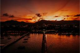 Sunset view over hotel waterfront with boats and pier