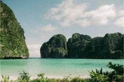 Seaside view with rocky cliffs and clear calm water