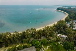 Aerial view of hotel beach area with coastline and greenery
