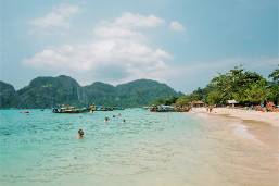 Hotel beach area with clear water and distant islands