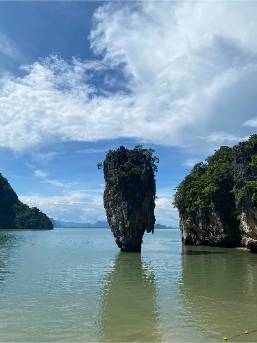 Unique limestone rock formation in calm coastal waters near resort area