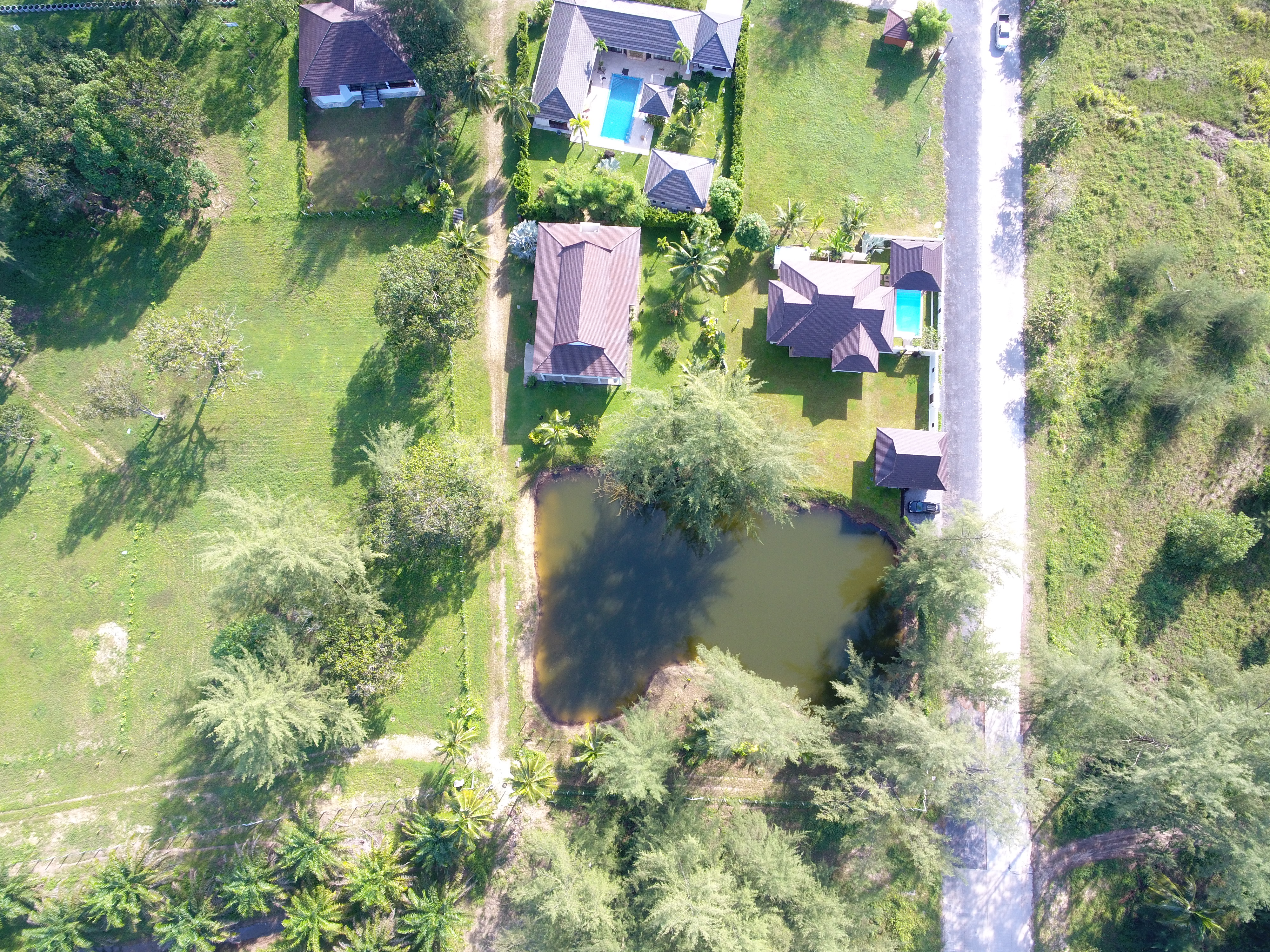 Owner-supplied aerial/drone still from the Thai Life Beach House property archive (DJI_0119). Useful for understanding the property and surrounding setting; it should not be treated as a survey or boundary plan.