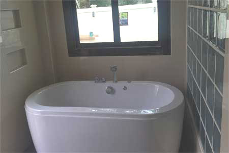 Property archive image for Thai Life Beach House showing modern white freestanding bathtub bathroom. Supplied from the Thai Life Beach House media archive; where capture date is not known, buyers should confirm current condition for decision-critical details.