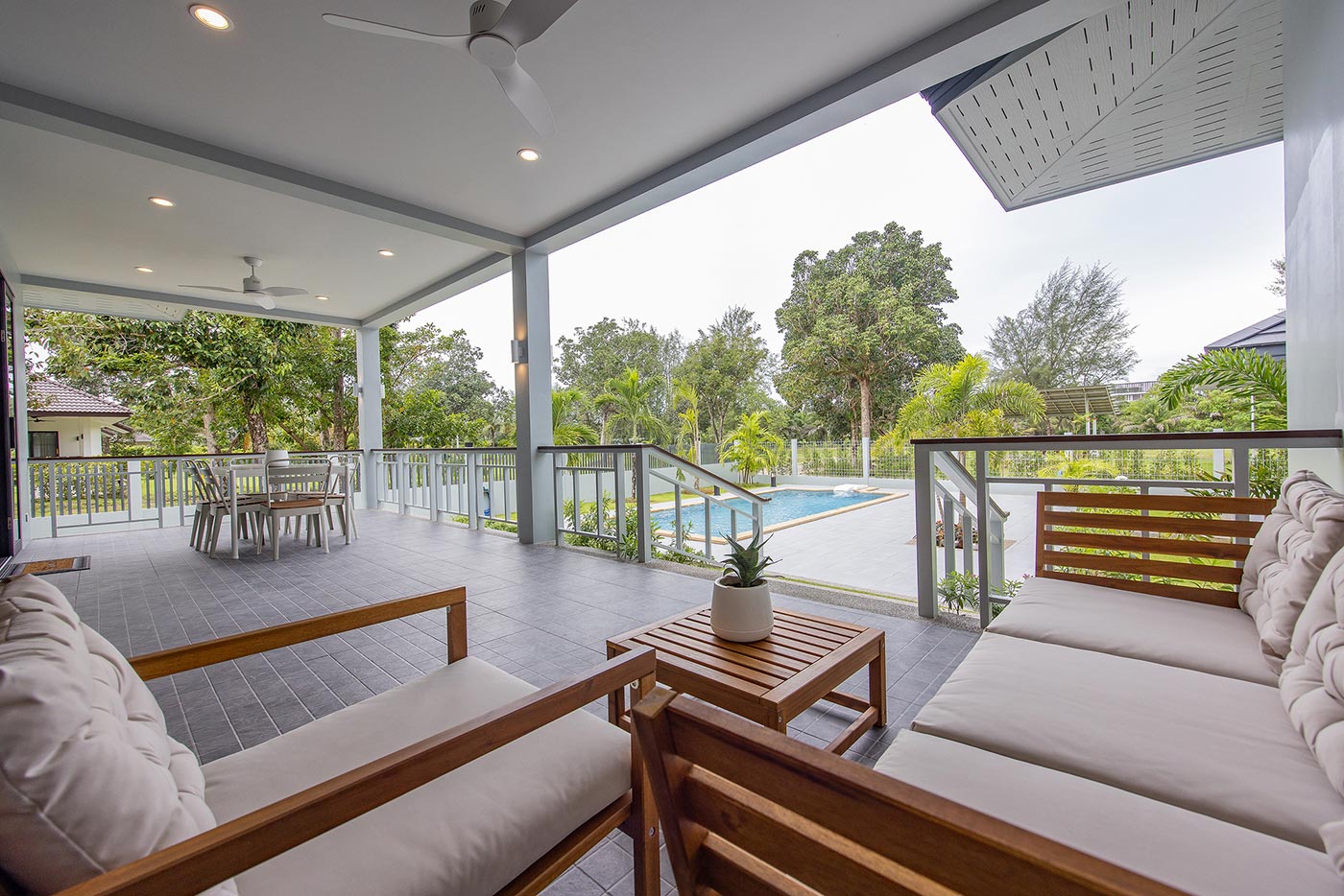 Official ThaiLife Residences project image showing covered patio with pool view for the Bang Muang, Takua Pa development. Confirm whether the image is completed-property photography, a show unit or a design visualisation before using it as construction-status evidence.