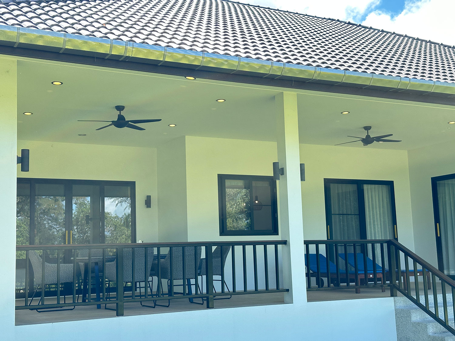 Official ThaiLife Residences project image showing covered residential porch dining chairs fans for the Bang Muang, Takua Pa development. Confirm whether the image is completed-property photography, a show unit or a design visualisation before using it as construction-status evidence.
