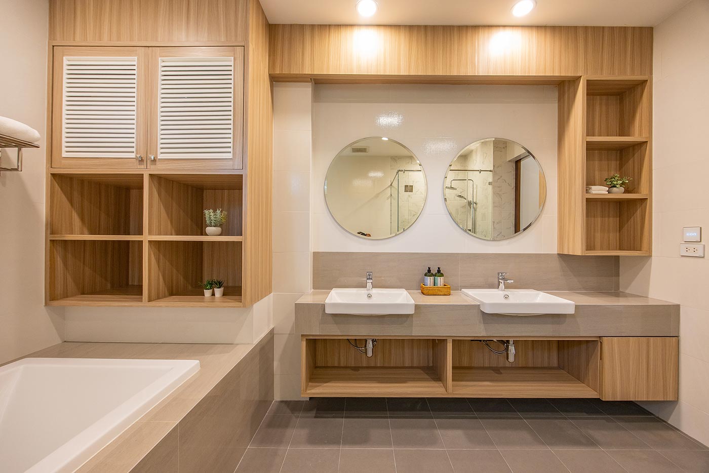 Official ThaiLife Residences project image showing modern bathroom double sink wooden cabinets for the Bang Muang, Takua Pa development. Confirm whether the image is completed-property photography, a show unit or a design visualisation before using it as construction-status evidence.