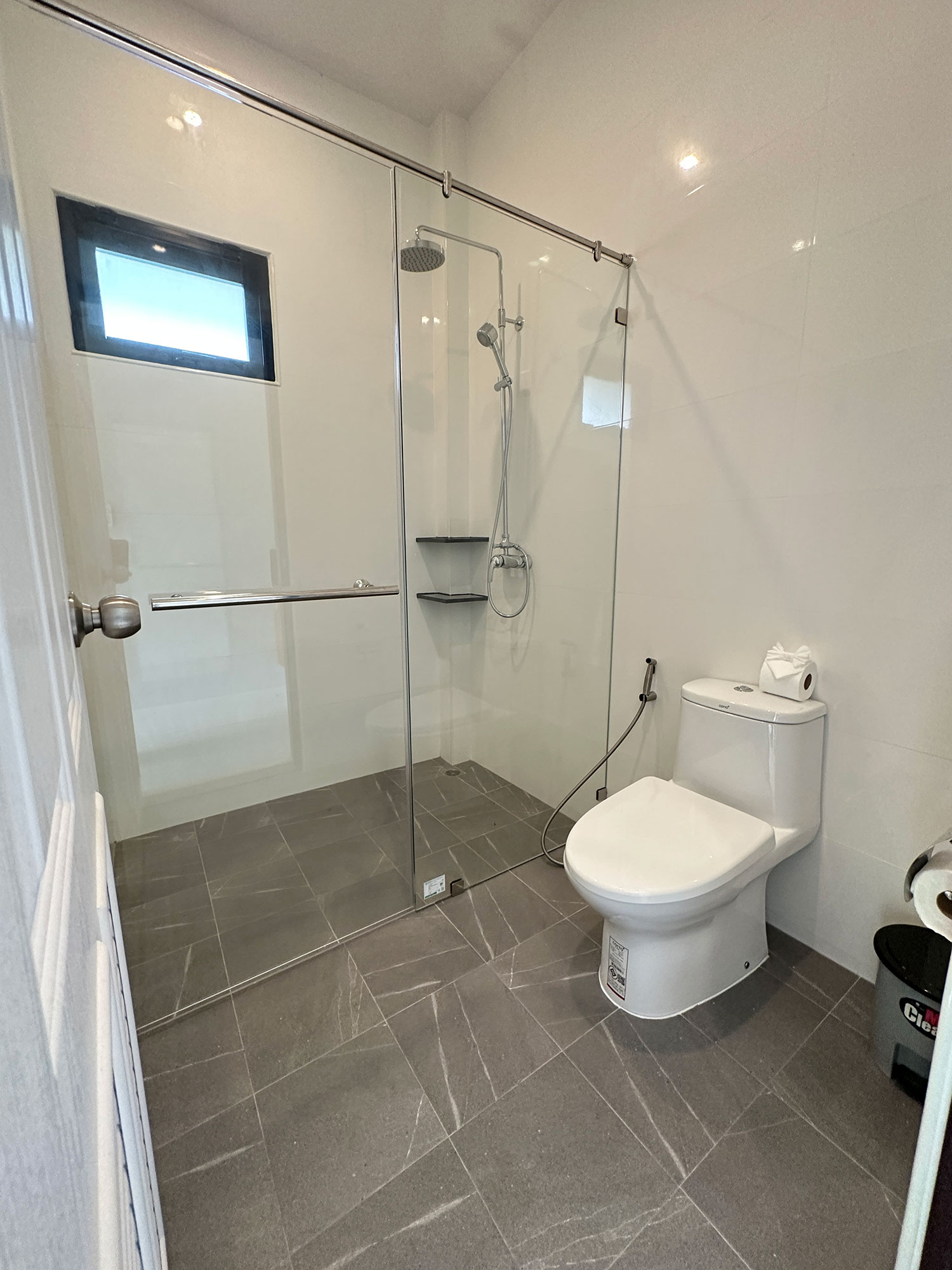 Official ThaiLife Residences project image showing modern bathroom with glass shower and toilet for the Bang Muang, Takua Pa development. Confirm whether the image is completed-property photography, a show unit or a design visualisation before using it as construction-status evidence.