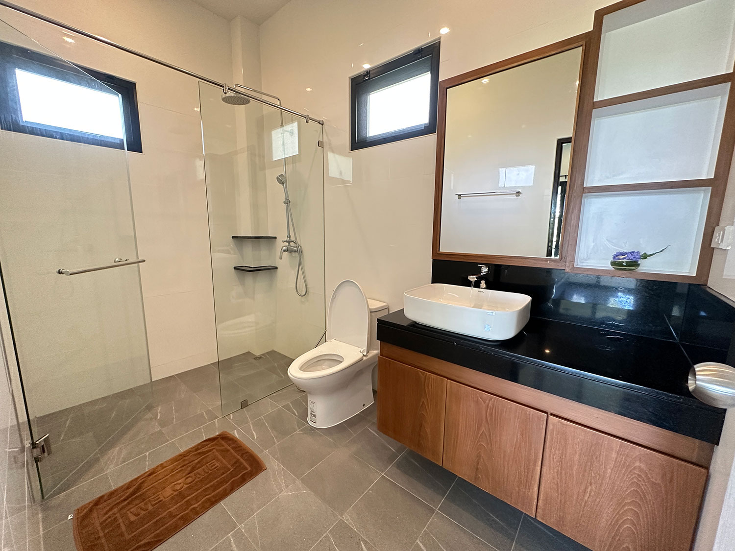 Official ThaiLife Residences project image showing modern bathroom with glass shower and vanity thailife residences for the Bang Muang, Takua Pa development. Confirm whether the image is completed-property photography, a show unit or a design visualisation before using it as construction-status evidence.