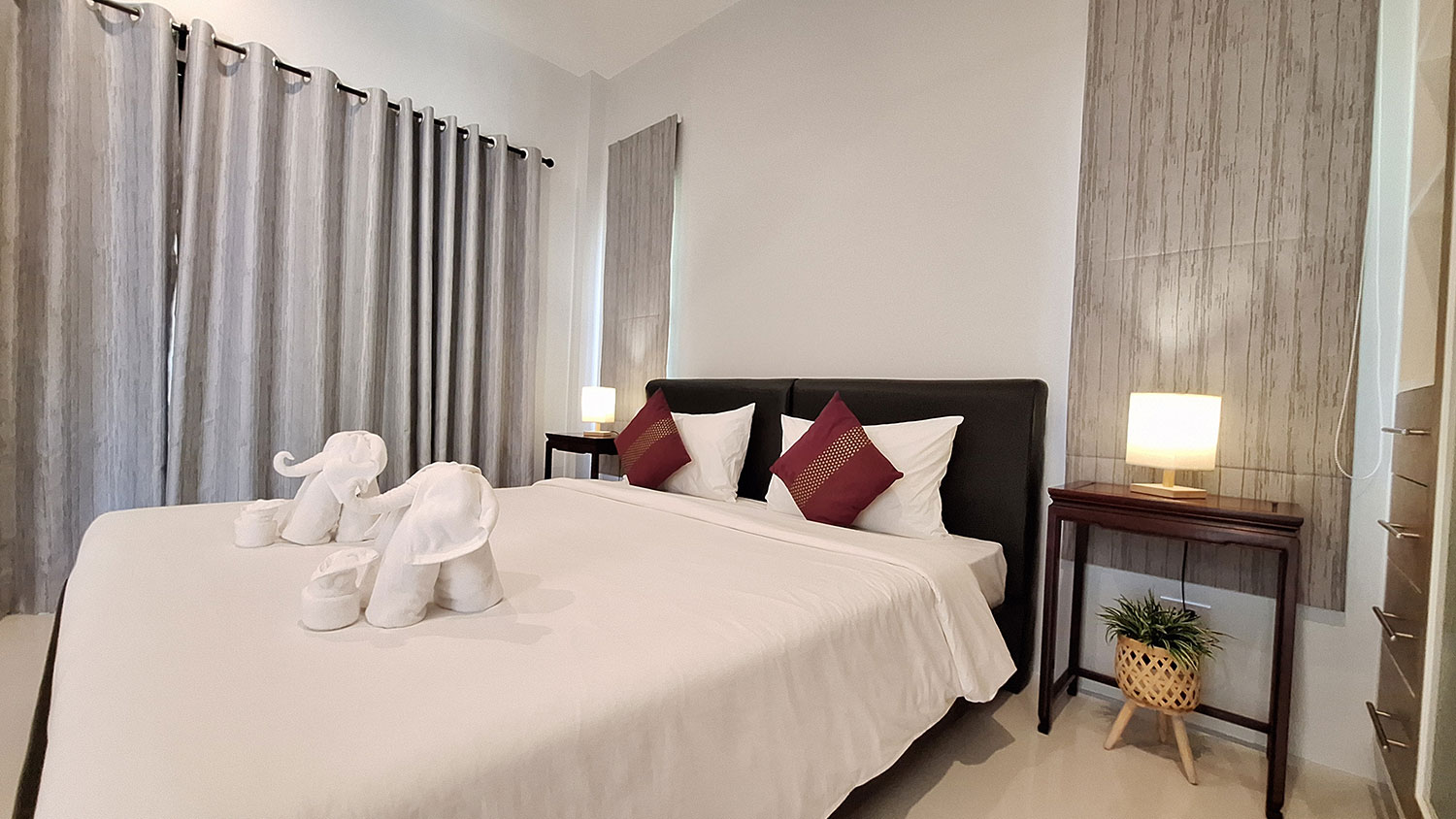 Official ThaiLife Residences project image showing modern bedroom with decorative towels for the Bang Muang, Takua Pa development. Confirm whether the image is completed-property photography, a show unit or a design visualisation before using it as construction-status evidence.