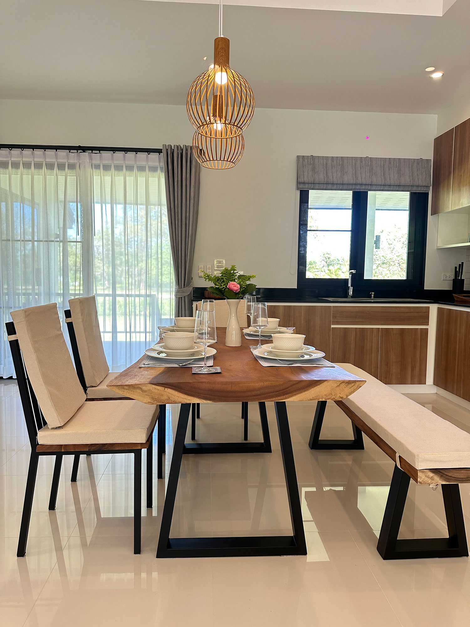 Official ThaiLife Residences project image showing modern dining area wooden table chairs for the Bang Muang, Takua Pa development. Confirm whether the image is completed-property photography, a show unit or a design visualisation before using it as construction-status evidence.