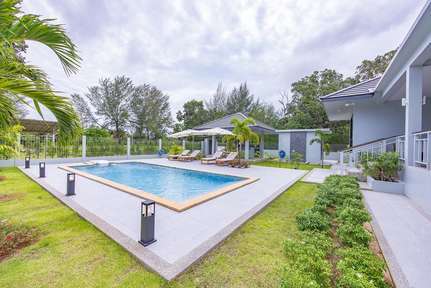 Official ThaiLife Residences project image showing modern home swimming pool garden area for the Bang Muang, Takua Pa development. Confirm whether the image is completed-property photography, a show unit or a design visualisation before using it as construction-status evidence.