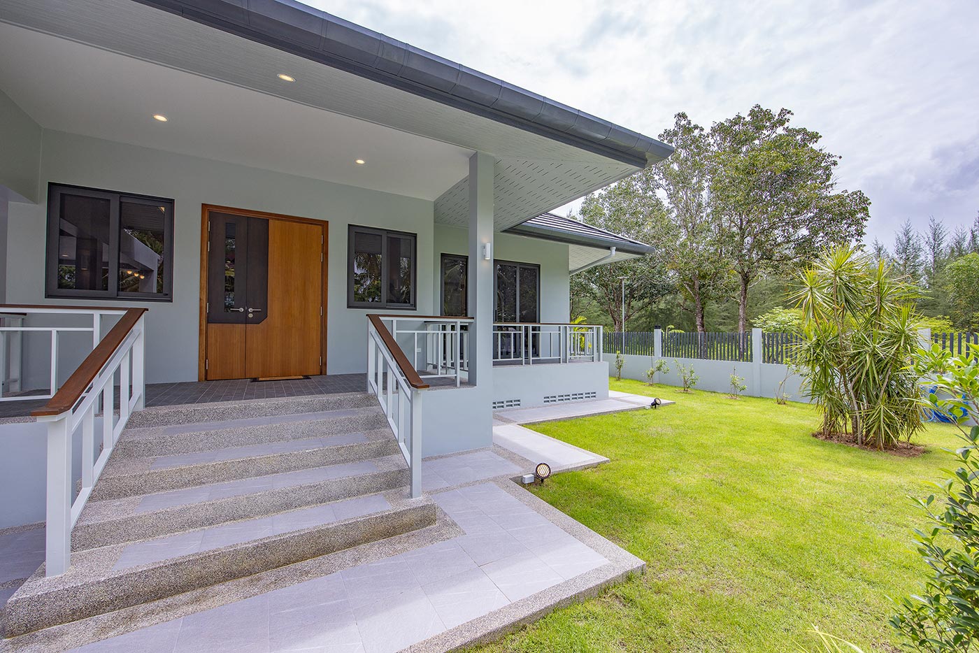 Official ThaiLife Residences project image showing modern house entrance front yard garden for the Bang Muang, Takua Pa development. Confirm whether the image is completed-property photography, a show unit or a design visualisation before using it as construction-status evidence.