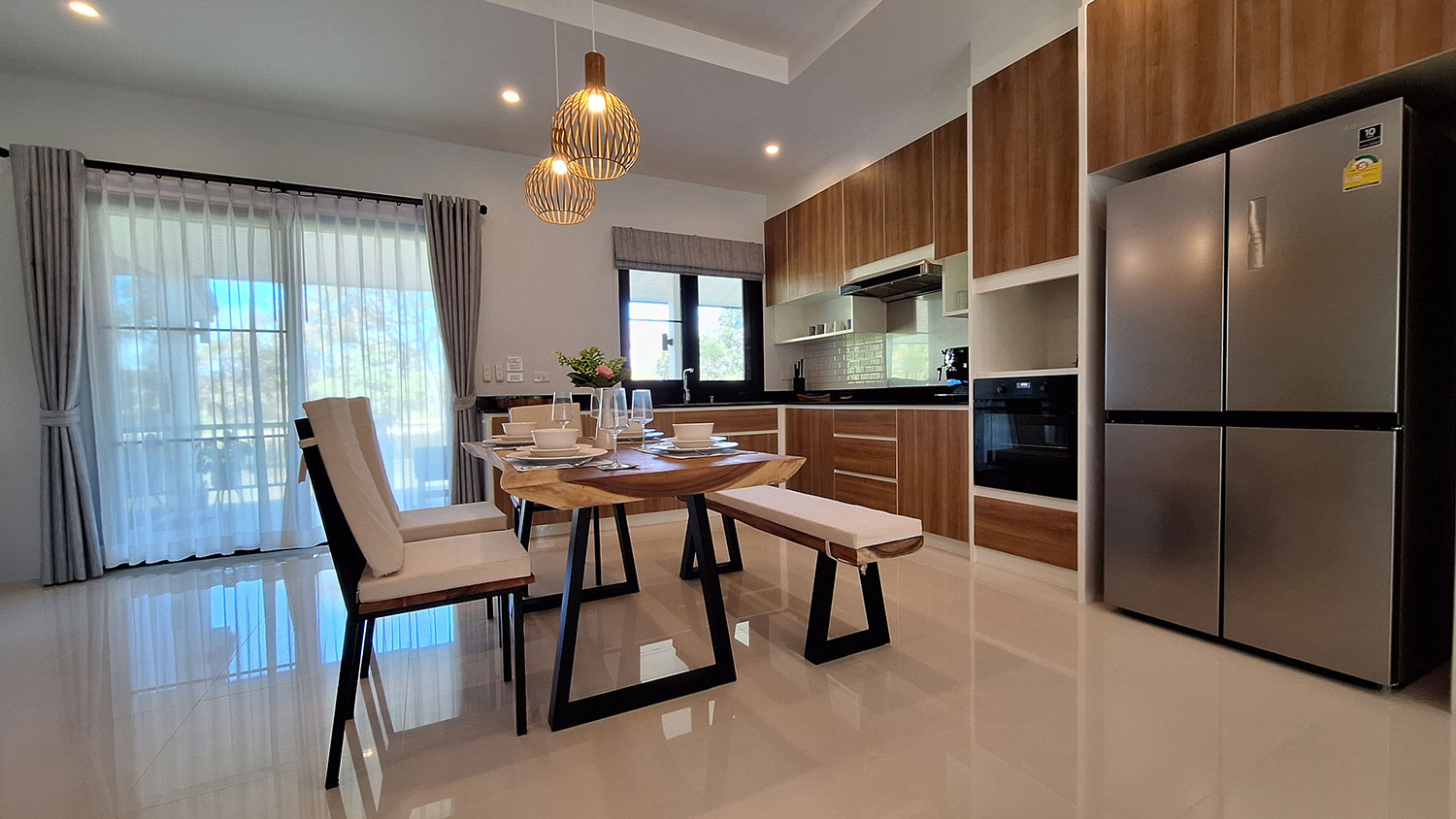 Official ThaiLife Residences project image showing modern kitchen dining area real estate for the Bang Muang, Takua Pa development. Confirm whether the image is completed-property photography, a show unit or a design visualisation before using it as construction-status evidence.
