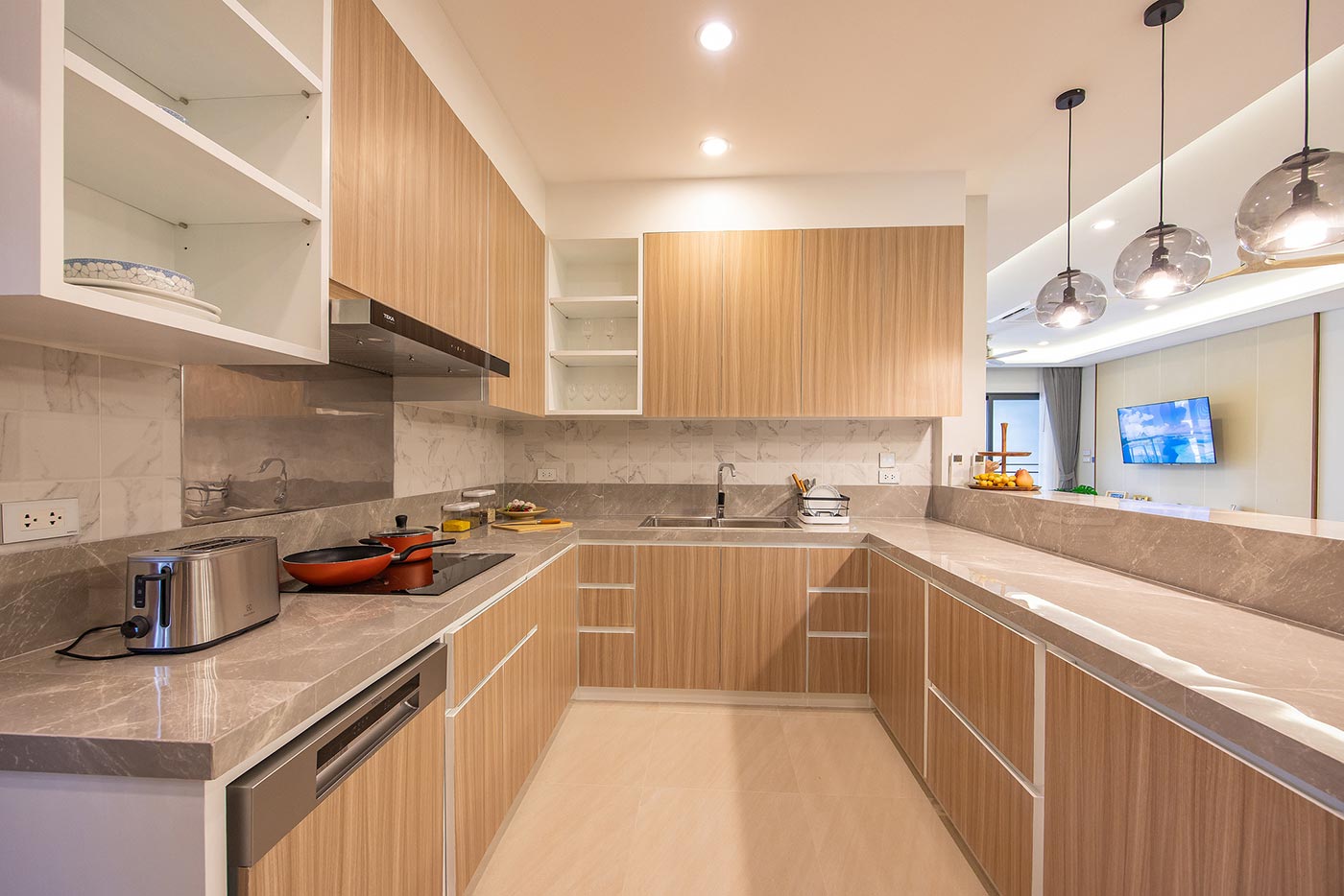 Official ThaiLife Residences project image showing modern kitchen with wood cabinets and marble counter for the Bang Muang, Takua Pa development. Confirm whether the image is completed-property photography, a show unit or a design visualisation before using it as construction-status evidence.