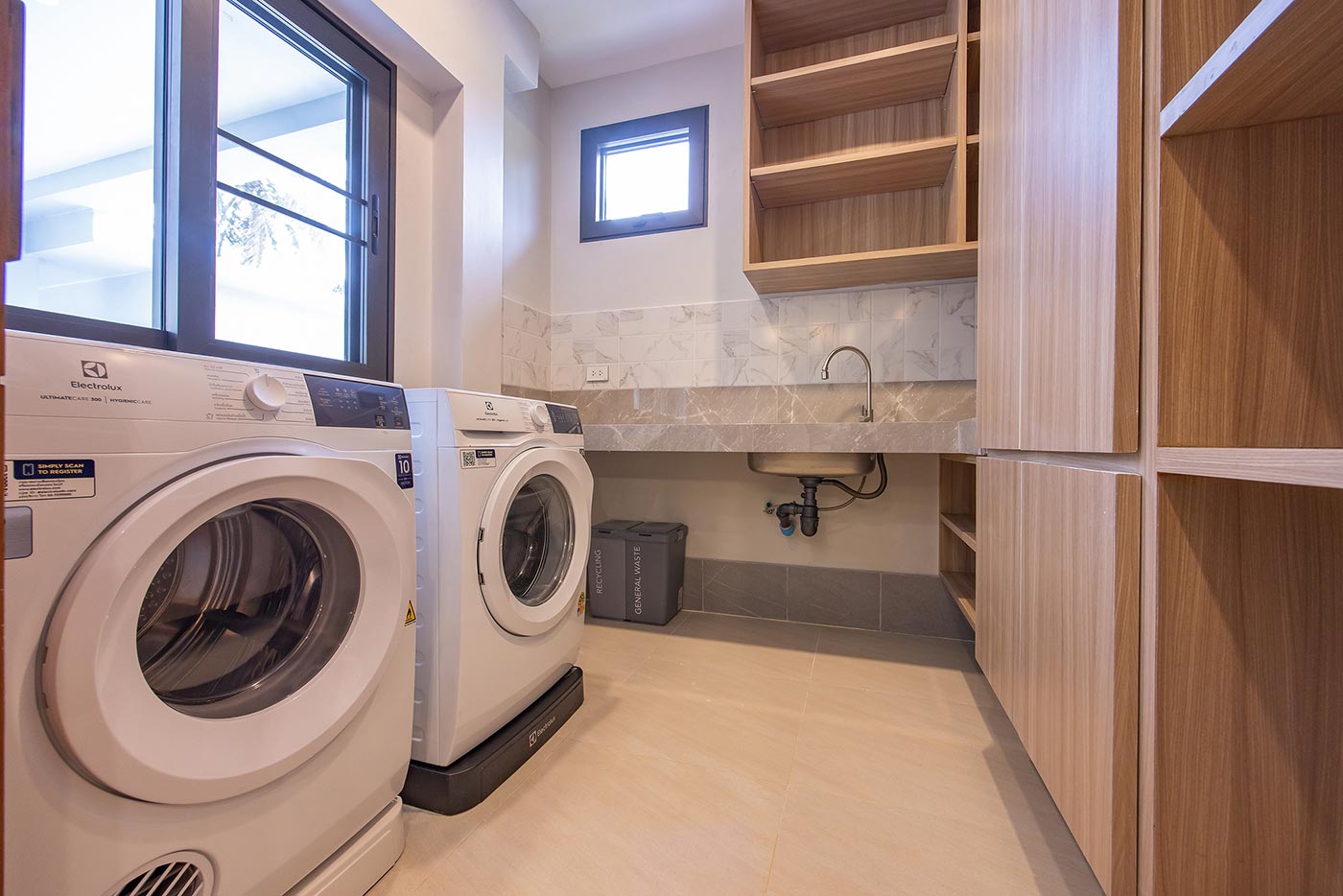 Official ThaiLife Residences project image showing modern laundry room with washer dryer for the Bang Muang, Takua Pa development. Confirm whether the image is completed-property photography, a show unit or a design visualisation before using it as construction-status evidence.
