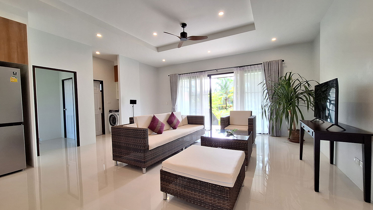 Official ThaiLife Residences project image showing modern living room apartment with balcony for the Bang Muang, Takua Pa development. Confirm whether the image is completed-property photography, a show unit or a design visualisation before using it as construction-status evidence.
