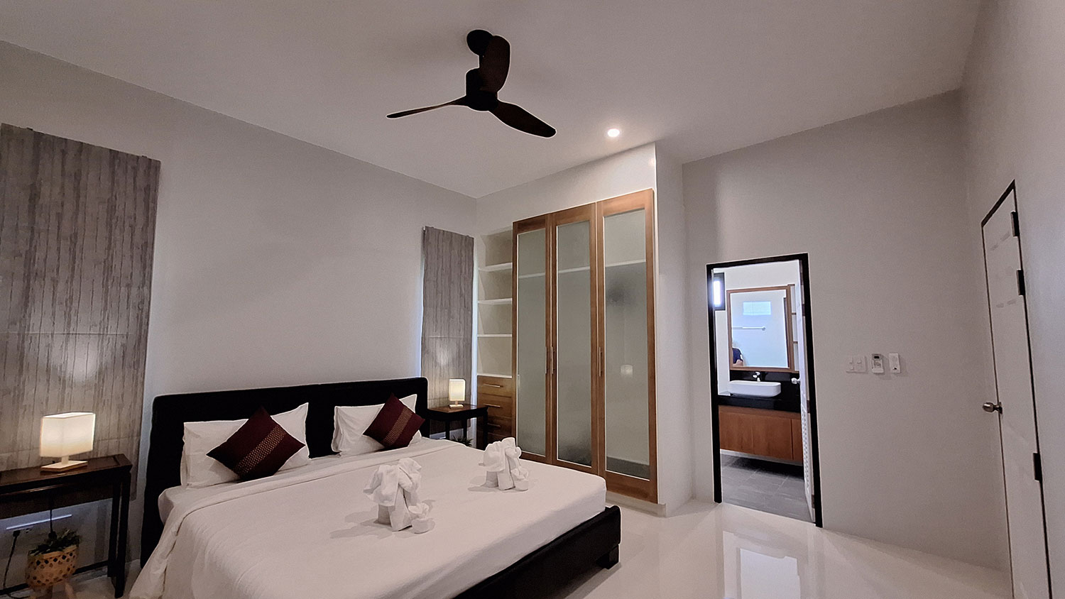 Official ThaiLife Residences project image showing modern master bedroom with ensuite bathroom for the Bang Muang, Takua Pa development. Confirm whether the image is completed-property photography, a show unit or a design visualisation before using it as construction-status evidence.