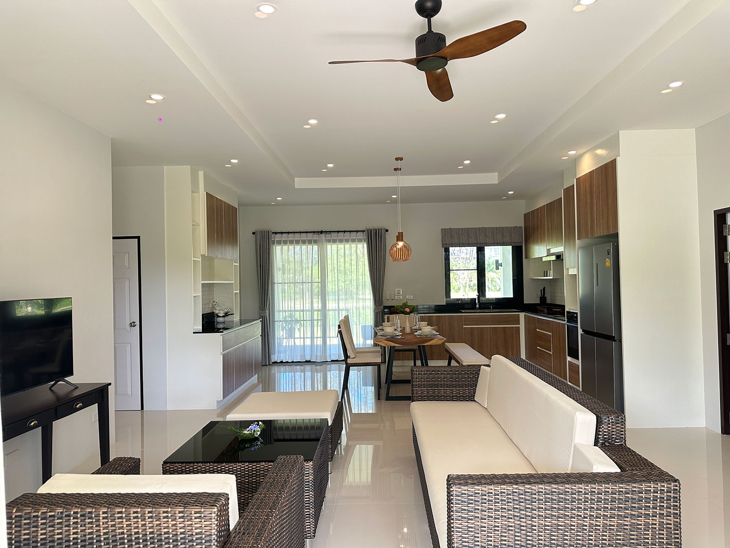 Official ThaiLife Residences project image showing modern open plan living room kitchen for the Bang Muang, Takua Pa development. Confirm whether the image is completed-property photography, a show unit or a design visualisation before using it as construction-status evidence.