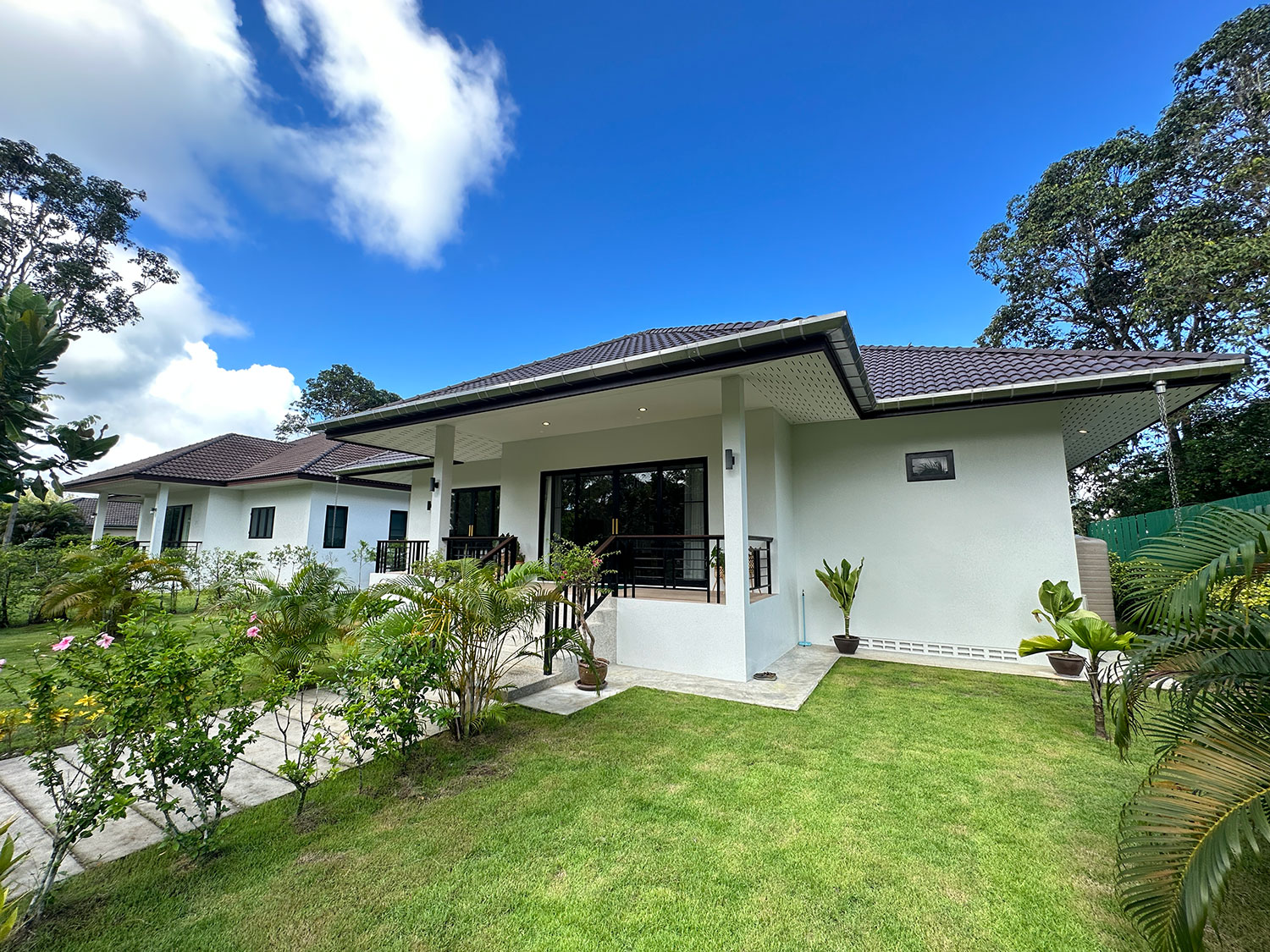 Official ThaiLife Residences project image showing modern single story home exterior lawn for the Bang Muang, Takua Pa development. Confirm whether the image is completed-property photography, a show unit or a design visualisation before using it as construction-status evidence.